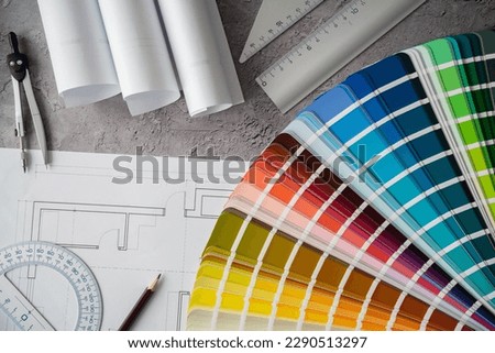 Home floor plans or building blueprint project and open color palette guide catalog with colour swatches. Architect or interior designer concept. Choosing paint colors for house, flat or apartment.