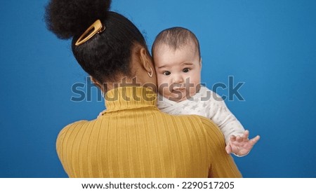 Mother and son hugging each other over isolated blue background