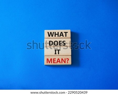 What does it mean symbol. Wooden blocks with words What does it mean. Beautiful blue background. Business and What does it mean concept. Copy space.