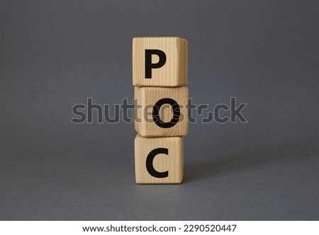 POC - Proof of Concept symbol. Wooden cubes with words POC. Beautiful grey background. Business and POC concept. Copy space.