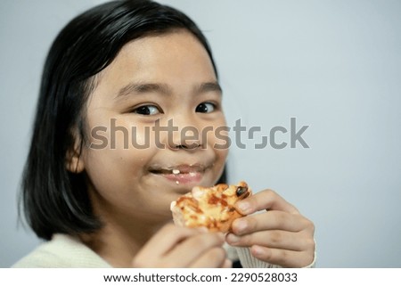 Pizza and kids concept, kid eating pizza food on white background, child open mouse and holding pizza to big mouse for eat, fast food for children hungry food and tasty, photo for creative white wal