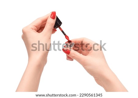 Red liquid lipstick in woman hands with red nails isolated on a white background. Copy space.