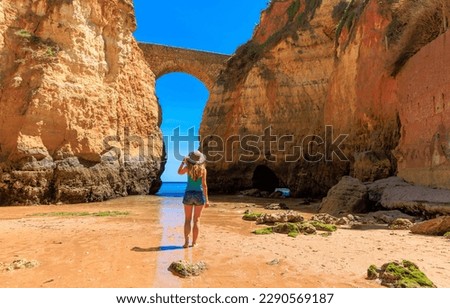 tour tourism in Algarve- Ponte Romana de Lagos- Happy woman traveling in Portugal- arch in rock Royalty-Free Stock Photo #2290569187