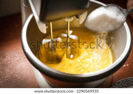 cooking process beat eggs and add sugar with an electric mixer, cooking baking cooking Royalty-Free Stock Photo #2290569935
