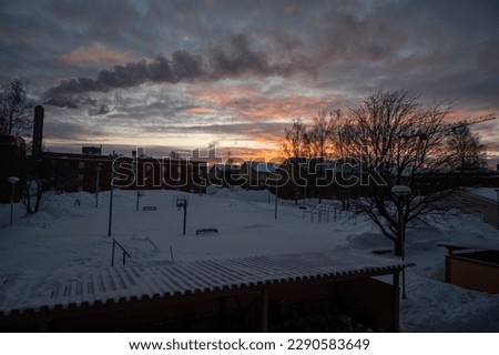 Panoramic view of beautiful winter wonderland scenery in scenic golden evening light at sunset with clouds in Scandinavia, northern Europe. Industrial pollution.