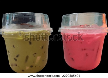 Green Tea and Pink Milk popular sweet drink in summer in Thailand, isolated on a black background.no focus