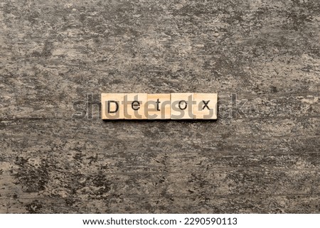detox word written on wood block. detox text on cement table for your desing, concept. Royalty-Free Stock Photo #2290590113