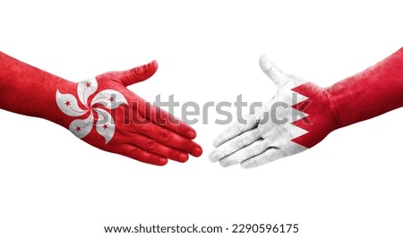 Handshake between Bahrain and Hong Kong flags painted on hands, isolated transparent image.