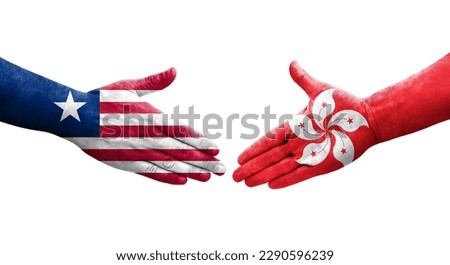 Handshake between Hong Kong and Liberia flags painted on hands, isolated transparent image.