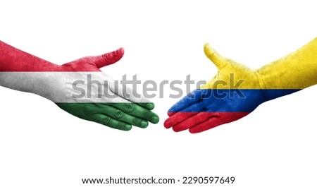 Handshake between Colombia and Hungary flags painted on hands, isolated transparent image.
