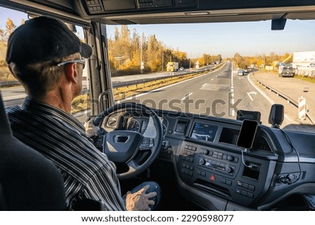 View from inside the cab of the truck. Car transport. The truck is driving down the road. Royalty-Free Stock Photo #2290598077