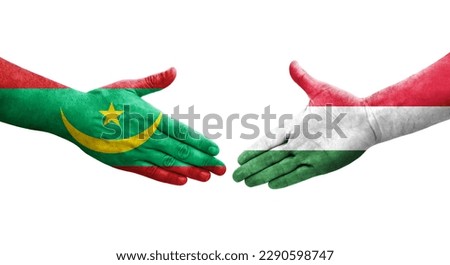 Handshake between Hungary and Mauritania flags painted on hands, isolated transparent image.