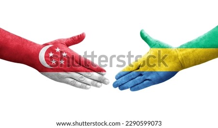 Handshake between Gabon and Singapore flags painted on hands, isolated transparent image.