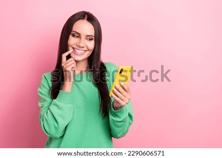 Portrait of adorable person wear green pullover holding smartphone searching boyfriend in date app isolated on pink color background