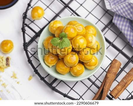 Nastar Cookies, Pineapple tarts or nanas tart are small, bite-size pastries filled or topped with pineapple jam, commonly found when Hari Raya or Eid Al Fitr or Lebaran. Selective focus  Royalty-Free Stock Photo #2290606679