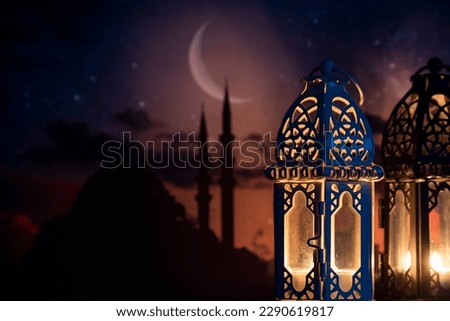 Ramadan Kareem greeting photo of beautiful Arabic lantern and mosque in the background representing the Islamic Holy Month.   Royalty-Free Stock Photo #2290619817