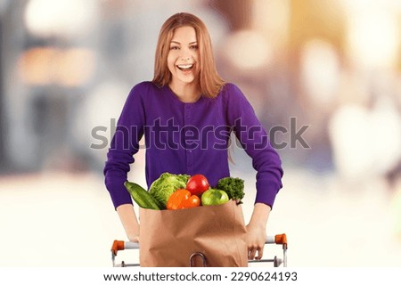 Young happy woman after shopping on outdoor background