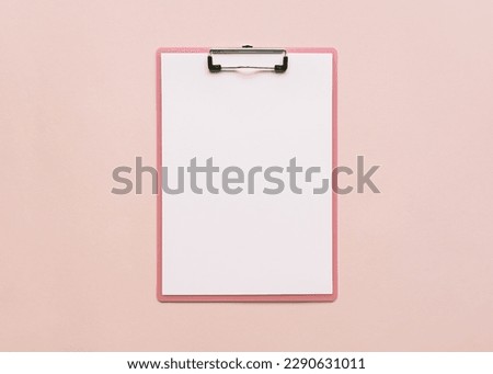 pink clipboard with blank white sheet of a4 paper on pink background. flat lay, space for text Royalty-Free Stock Photo #2290631011