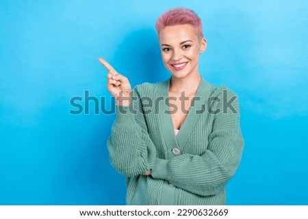 Photo of cheerful lovely lady raise arm direct empty space recommend hairdresser stylist isolated on blue color background