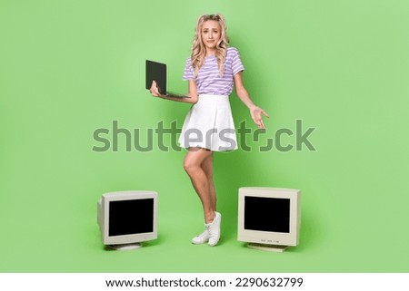 Full length photo of doubtful unsure lady dressed purple t-shirt working modern device instead obsolete isolated green color background