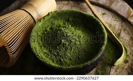 Matcha green tea powder in a bowl with a whisk for whipping and tea bamboo spoon Royalty-Free Stock Photo #2290637627