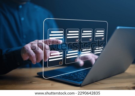 Document management system DMS. Assessment form, questionnaire, checklist and clipboard task management. Businessman working on laptop computer productivity checklist and filling survey form online. Royalty-Free Stock Photo #2290642835