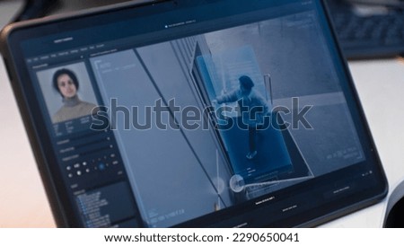 Playback from CCTV cameras in coworking office displayed on digital tablet computer screen. High tech program with facial recognition showing surveillance cameras footage. Monitoring and social safety Royalty-Free Stock Photo #2290650041