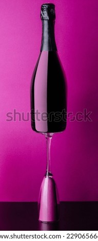 concept of bottle and glass of pink rose champagne