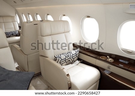 Comfortible chairs in a modern business jet aircraft Royalty-Free Stock Photo #2290658427