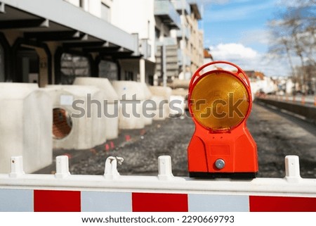 Warning orange-red signal at a construction site. Close up.