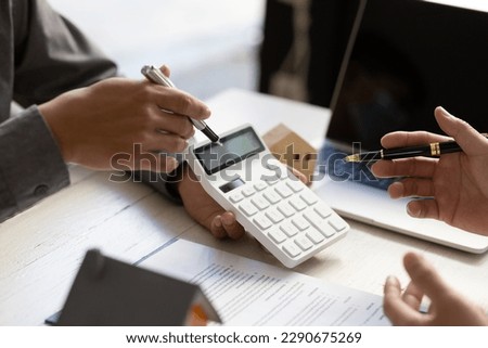 Real estate agent discuss about the terms of the home purchase agreement and asked the customer to sign the documents to make the contract legally, Home sales, lease, mortgage and home insurance. Royalty-Free Stock Photo #2290675269