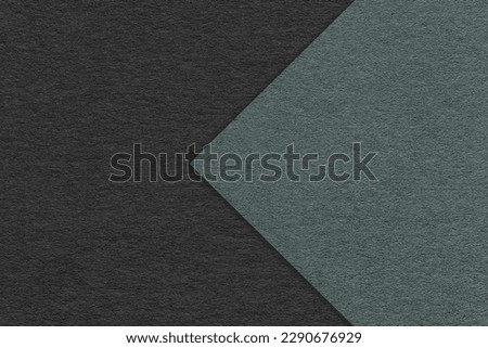 Texture of black paper background, half two colors with dark green arrow, macro. Structure of dense craft olive cardboard. Felt abstract backdrop closeup. Royalty-Free Stock Photo #2290676929