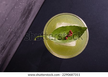 Basil cocktail with gin, basil juice and pepper served in an evening cocktail bar