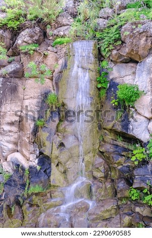 Beautiful view on cascading waterfall in cactus park of Las Palmas, Gran Canary, Spain