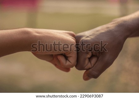 Two hands are wrapped together and the background is blurred
