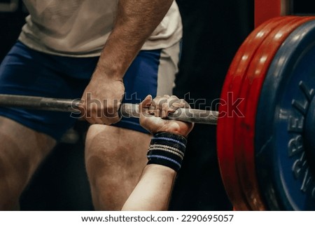 hand male powerlifter hold barbell bar before bench press powerlifting competition, power sports games Royalty-Free Stock Photo #2290695057