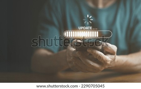 Businessman using mobile phone loading data with loading bar icon over a wireless , update concept and business transformation Loading icon on screen. Royalty-Free Stock Photo #2290705045