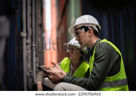 Engineer or Foreman using reality glasses simulation working with hologram control or check inventory details of containers box in container yard reality development process concept