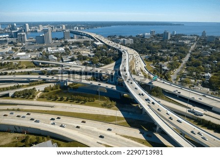 Aerial view of american freeway intersection with fast moving cars and trucks. USA transportation infrastructure concept Royalty-Free Stock Photo #2290713981