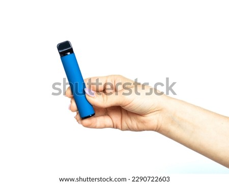  Female hand holds electronic cigarette on a white background. Disposable electronic cigarette. concept of modern smoking, vaping and nicotine. copyspace. Alternative way of smoking vaping device Royalty-Free Stock Photo #2290722603