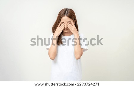 Young asian beautiful woman hand rubbing eyes she's feeling depressed stress headache be tired from working standing on isolated white background she has health problems. Royalty-Free Stock Photo #2290724271