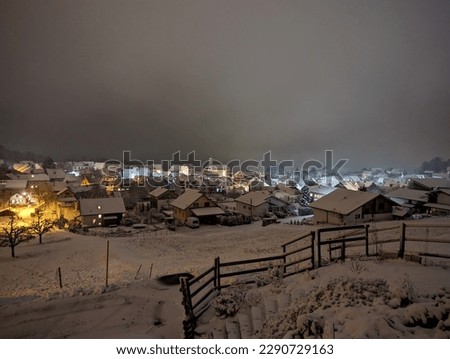 View of the village at night in winter. View from the terrace. Switzerland