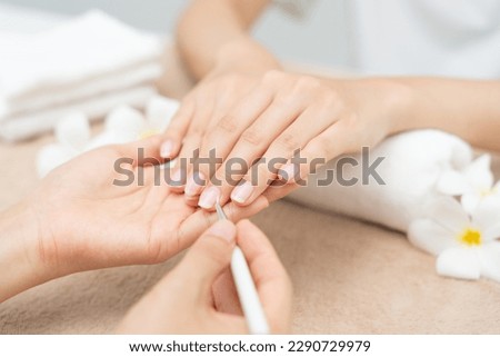 Woman receive care service by professional Beautician Manicure at spa centre. Nail beauty salon use nail file for Glazing treatment. manicurist make nail customer to beautiful. body care spa treatment Royalty-Free Stock Photo #2290729979