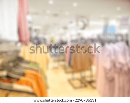 Defocused Abstract Background aisle of female clothes store hanging on rack in departement store inside modern Shopping Mall or Shopping Center. with vintage tone effect