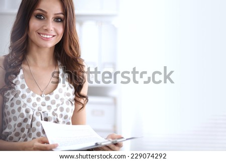 Young happy businesswoman in office holding  folder