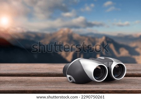 Binoculars on desk at rock mountain with beautiful nature background.