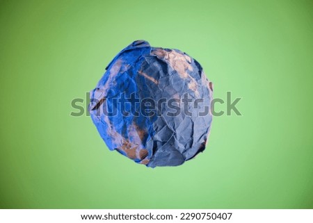 Planet earth created with paper and crumpled up to represent planet drought and destruction, earth day.