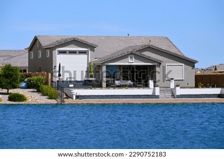 new waterfront homes at The Lakes community at Rancho El Dorado in Maricopa, Arizona featuring tall RV garages. Royalty-Free Stock Photo #2290752183