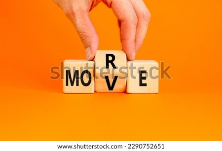 More move symbol. Concept word More move on wooden cubes. Beautiful orange table orange background. Businessman hand. Business and more move concept. Copy space. Royalty-Free Stock Photo #2290752651