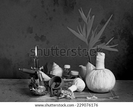 Still life art photography on spa concept with candle light and herbal massage balls black and white version